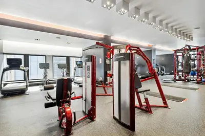 a gym with cardio equipment in a room at FiDi Studio w Work Setup by Anyplace - 11679 in New York
