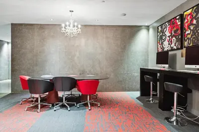 a dining room with a table and red chairs at FiDi Studio w Work Setup by Anyplace - 11679 in New York
