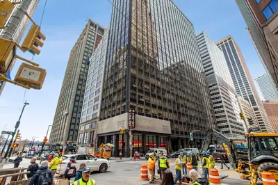 a group of construction workers on a busy city street at FiDi Studio w Work Setup by Anyplace - 11679 in New York