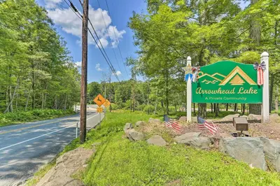 a sign for aucuildford bridge with two american flags at Games, Fire Pit, Hot Tub Pocono Lake Family Home! in Pocono Lake