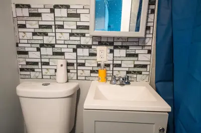 a bathroom with a toilet and a sink and a mirror at Casa Ebenecer - Habitación privada # 1 in Elizabeth