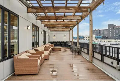a balcony with couches and tables on a building at Modern 2BR, 1BA Apartment in Great Location in Philadelphia