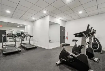 a gym with treadmills and ellipticals in a room at Sleek 1BR apartment in Philly in Philadelphia