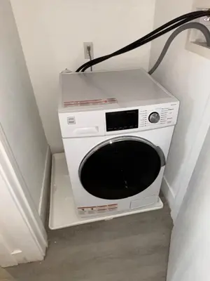 a microwave sitting in the corner of a room at Nice escape 8 min from EWR in Elizabeth