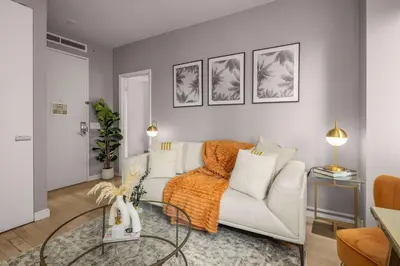 a living room with a white couch and a table at Chic NYC Retreat Beside Broadway in New York