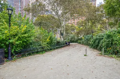 a dirt path in a park with trees and bushes at Blueground Financial District rooftop nr Brooklyn Bridge NYC-2201 in New York