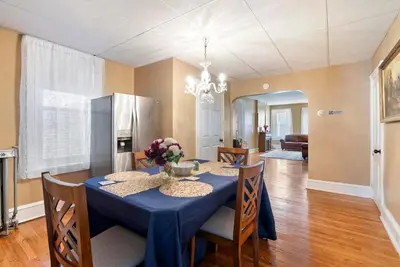 a dining room with a blue table and chairs at The Serenity Manor in Chester