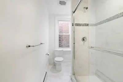 a white bathroom with a toilet and a shower at The Serenity Manor in Chester