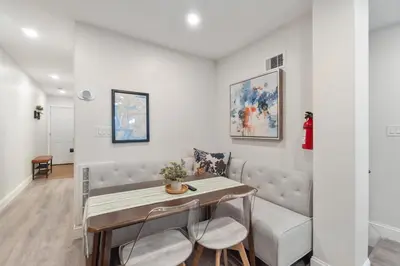 a living room with a table and a couch at Cozy 1BR level apartment w patio & workstation in Jersey City