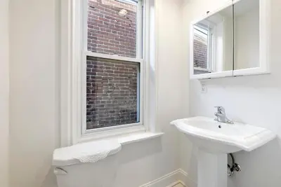 a white bathroom with a sink and a window at Moonbeam Suite-Private Room in Serenity Manor in Chester