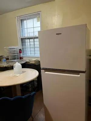 a white refrigerator in a kitchen with a table at 2131 Double Room F in Philadelphia