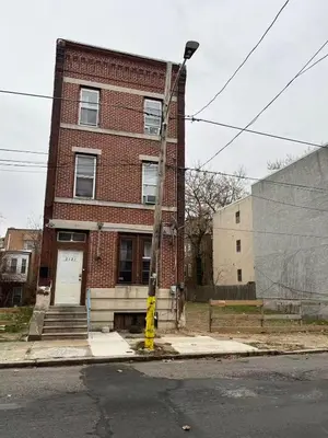 a brick building with a yellow pole in front of it at 2131 Double Room F in Philadelphia