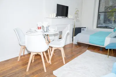 a room with a table and chairs and a bed at Elegant84 West Side Home 5 min to Central Park in New York
