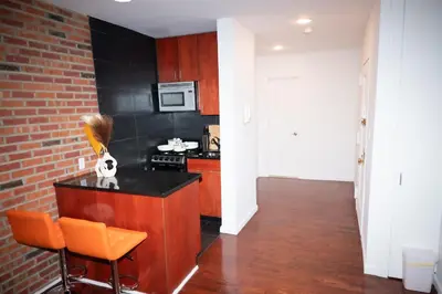 a kitchen with a counter and a stove top oven at West47 Village Getaway - Subway & Local Cafés in New York