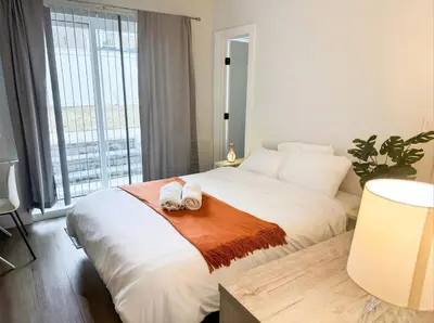 a bedroom with a bed with two towels on it at Easy-Access & Quick to NYC, EWR, Dream Mall, Stadium in Jersey City