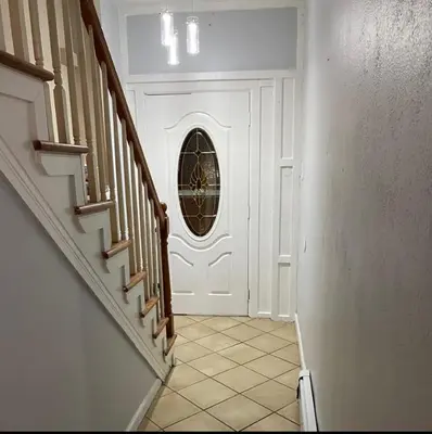 a hallway with a white door with a round window at Spacious Private Room with Private Bath in Paterson