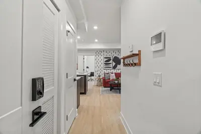 a hallway with a door leading to a living room at Urban 1BR Apartment Near Center City & University City in Philadelphia
