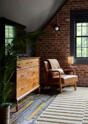 a living room with a dresser and a chair at Eleanor Inn - Suite Lorena in Warwick