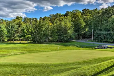a view of a golf course with a green at Poconos Retreat in The Hideout Lake Community! in Lake Ariel