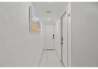 a hallway with white walls and a white door at Fairmount Park GSN Soil 2 in Philadelphia