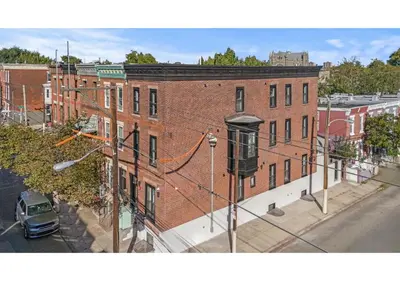 a large red brick building on a city street at Temple Town GSN Soil 3 in Philadelphia