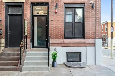 a brick house with a potted plant in front of it at Center City Philadelphia GSN Bloom 1 in Philadelphia