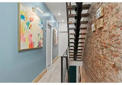 a hallway with a brick wall and a staircase at Center City Philadelphia GSN Bloom 1 in Philadelphia