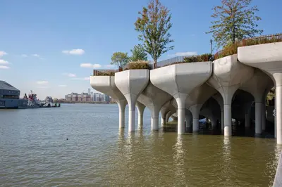 a building in the water next to a body of water at Chelsea 1br w doorman wd nr West Village NYC-1385 in New York