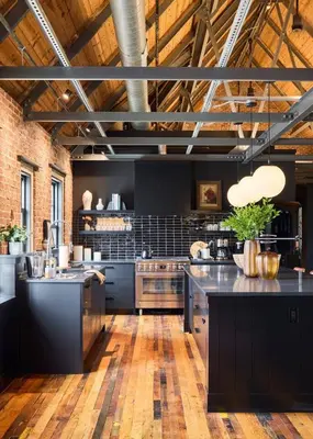 a large kitchen with black counter tops in a room at Eleanor Inn - Suite Amelia & Lorena in Warwick