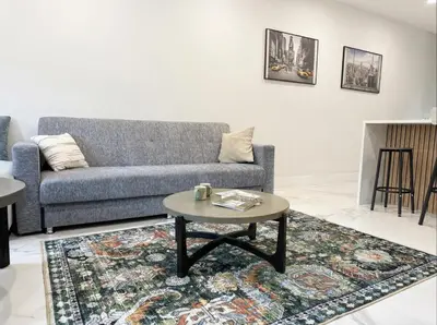 a living room with a couch and a coffee table at Furnished Private room with shared spaces in Jersey City