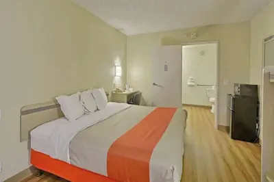 a bedroom with a large bed in a room at Red Carpet Inn And Suites in Maple Shade