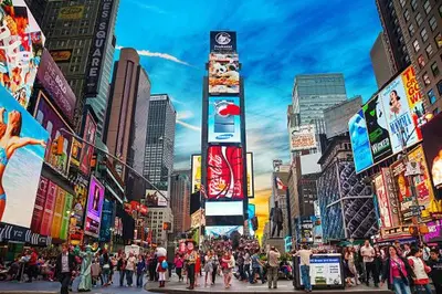 a crowd of people crossing a busy city street at Urban Haven XL - NYC & Newark with free parking in Newark
