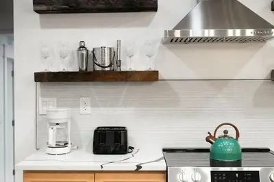 a kitchen with a counter with glasses on the wall at Modern Mountain Escape Sleeps Large Groups in Pocono Summit