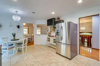 a kitchen and dining room with a stainless steel refrigerator at Hot Tub and Game Room Retreat Near Camelback in Reeders