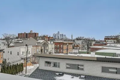 a view of a city from the roof of a building at 6 Mi to Manhattan Luxe Apt with City Views! in Jersey City