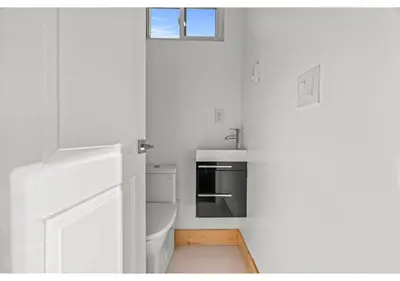 a white kitchen with a sink and a stove at Liberty bell GSN Harvest 1 in Philadelphia