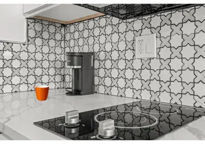a kitchen with black and white tiles on the wall at Liberty bell GSN Harvest 1 in Philadelphia