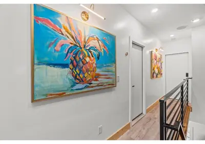 a painting of a pineapple hanging on a wall at Center city Philadelphia GSN Harvest 4 in Philadelphia