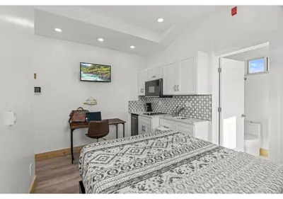 a white bedroom with a bed and a kitchen at Center city Philadelphia GSN Harvest 4 in Philadelphia