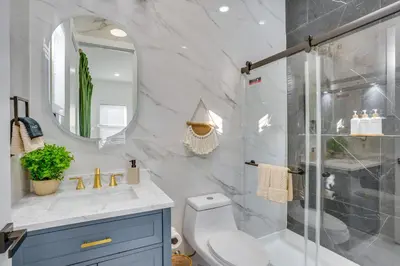 a bathroom with a shower and a toilet and a sink at Luxe Group Getaway 6 Mi to Manhattan! in Jersey City