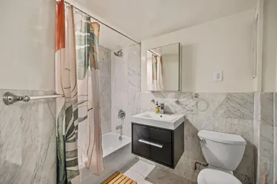 a bathroom with a toilet and a sink and a shower at The NYC Edition Times Square in New York