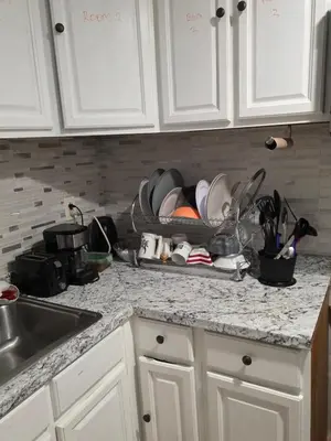 a kitchen counter with a dish rack full of dishes at Newly renovated 1 room in a 3-bedroom apartment with private toilet ands bathroom in Irvington