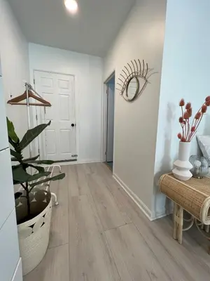 an empty hallway with a plant and a door at Chic Phoenixville Retreat With Parking in Phoenixville