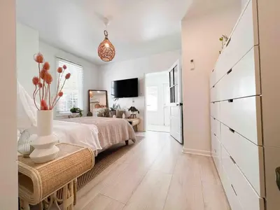a bedroom with a bed and a dresser in it at Chic Phoenixville Retreat With Parking in Phoenixville