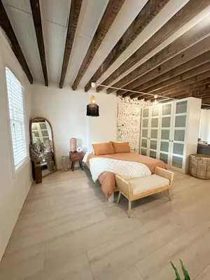 a bedroom with a bed and a chair in it at Queen Bed, Luxury Studio with Balcony in Phoenixville