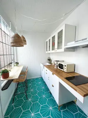 a kitchen with white cabinets and a blue floor at Home for 8, Parking & Patio in Phoenixville