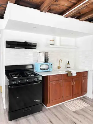 a kitchen with a black stove and a sink at Home for 8, Parking & Patio in Phoenixville