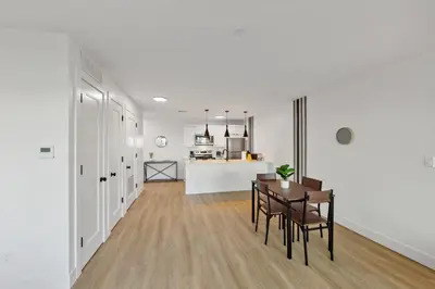 a living room and kitchen with a table and chairs at Market View Residence stunning 1bd Apt in Wilmington