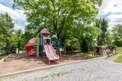 a playground with a slide in a park at Spring Gulch Cottage 1 in Mount Airy