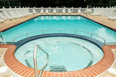 a large swimming pool with chairs around it at Spring Gulch Country House 9 in Mount Airy